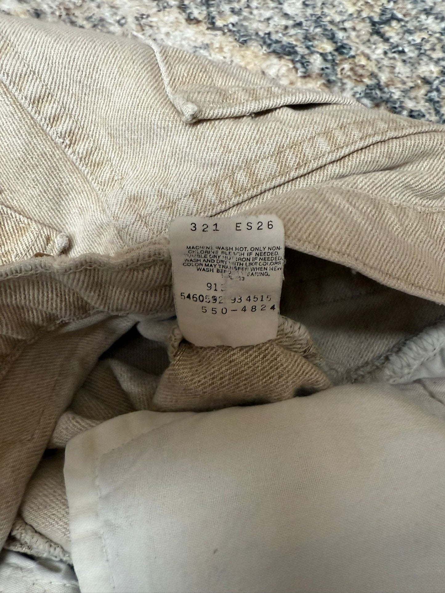 Close-up of beige fabric with a tag on a textured surface