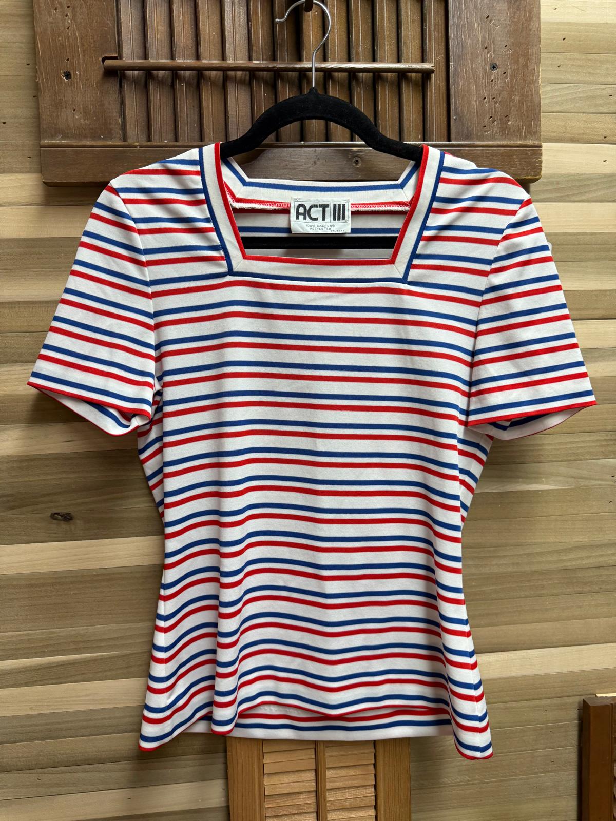 Striped shirt on a hanger against a wooden background