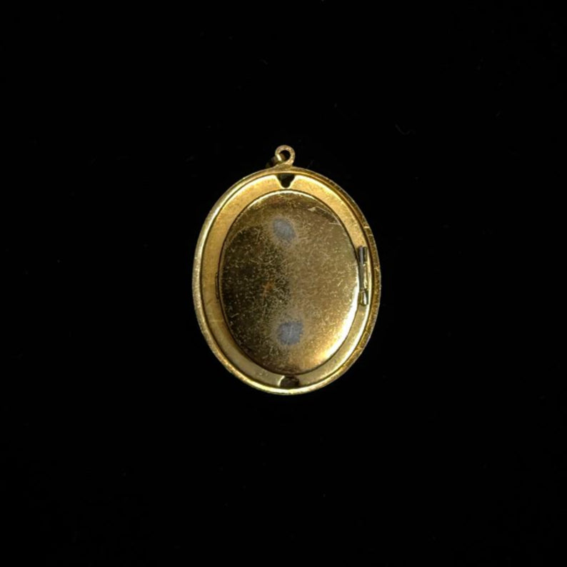 Gold pendant on a black background