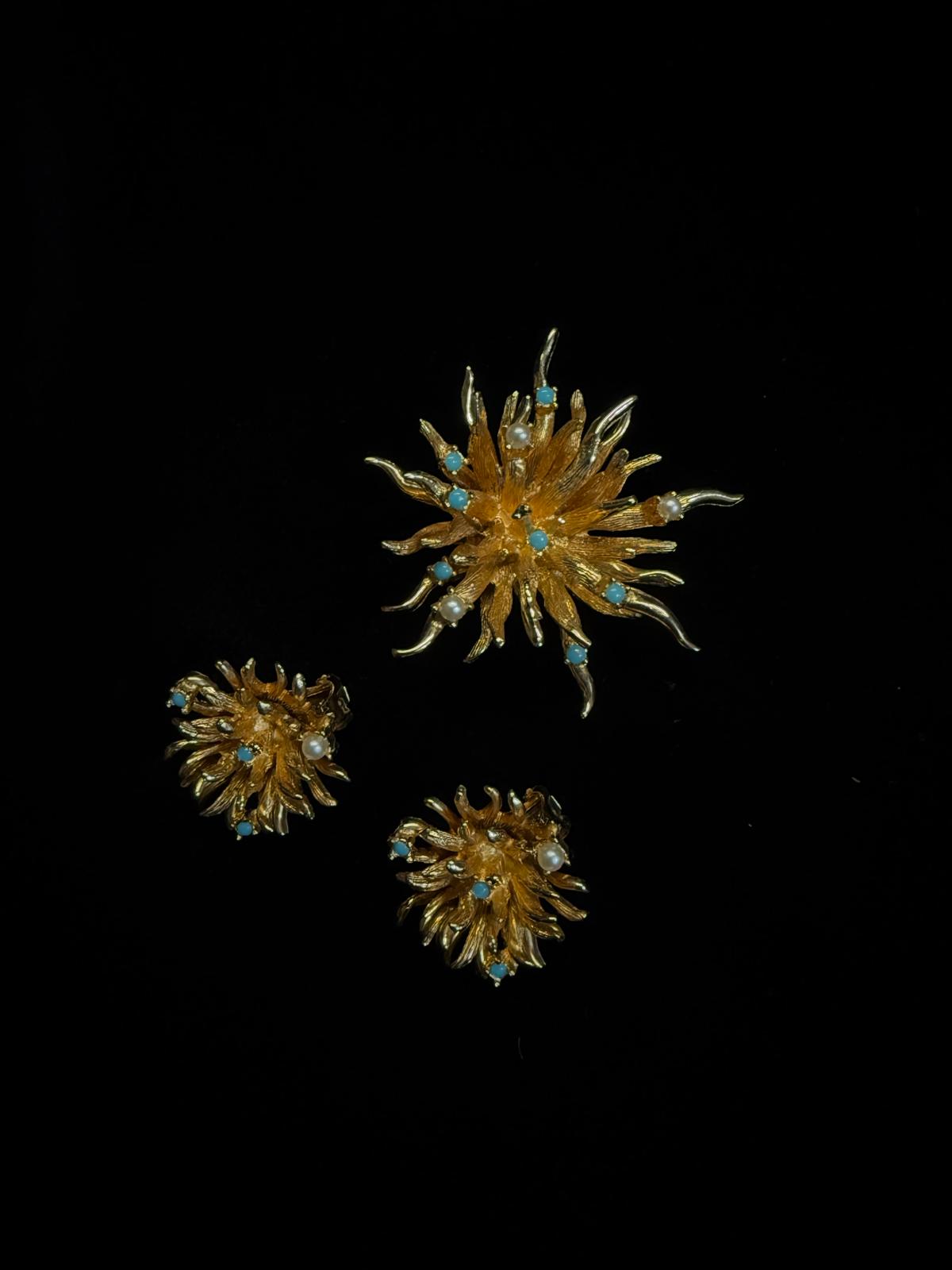 Set of three gold and blue decorative items on a black background