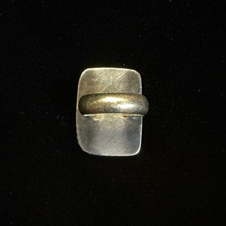 Small metallic object on a black background