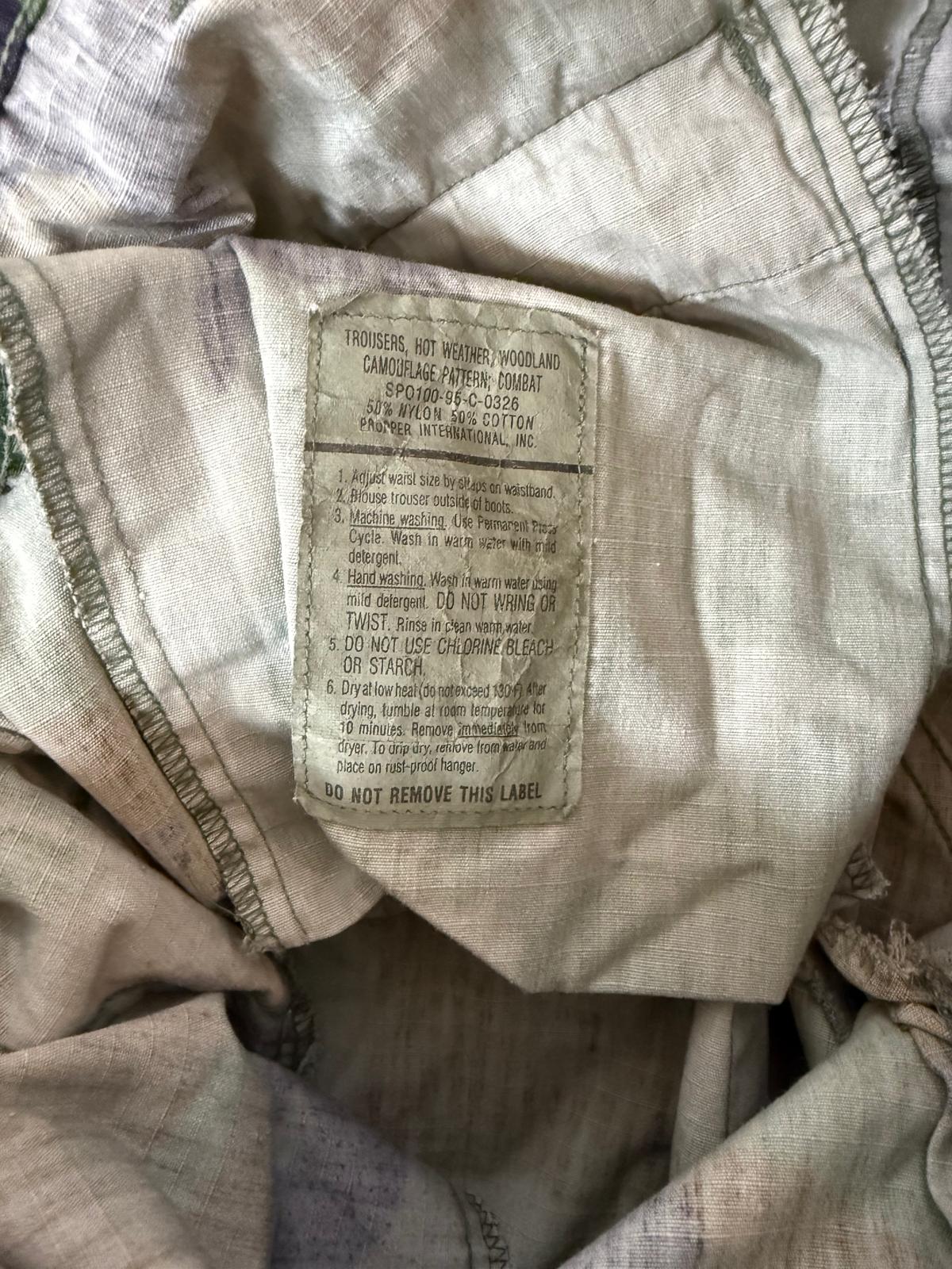 Close-up of a label on a beige fabric item with text.