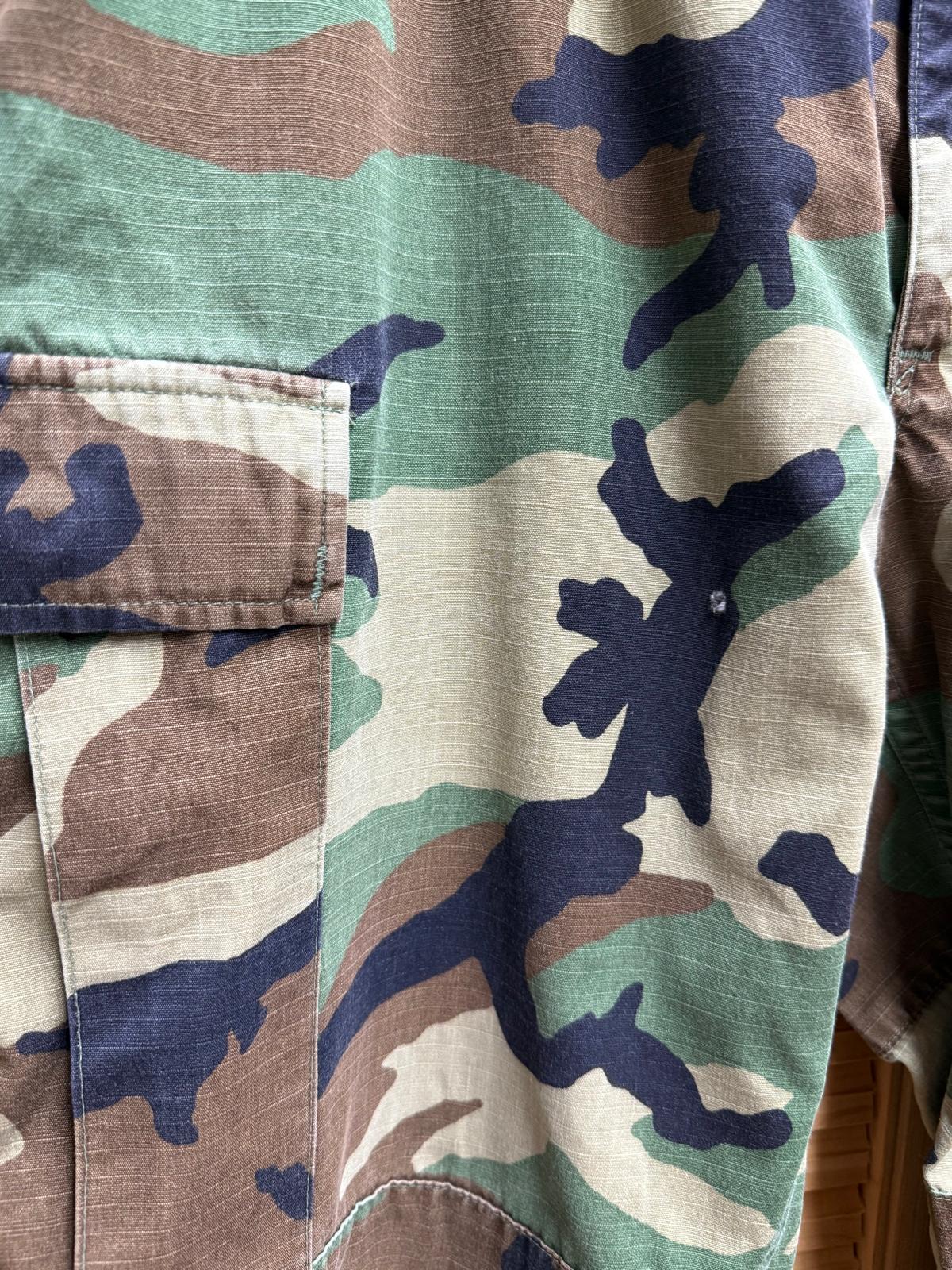 Close-up of a camouflage-patterned fabric with a pocket.