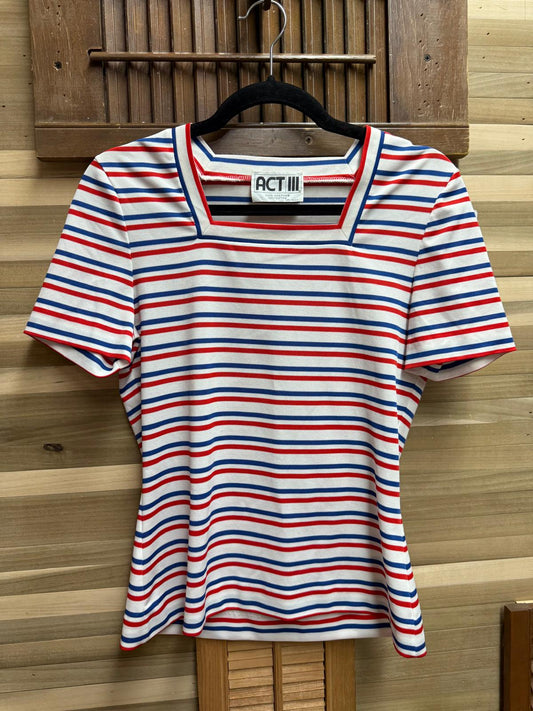 Striped shirt on a hanger against a wooden background