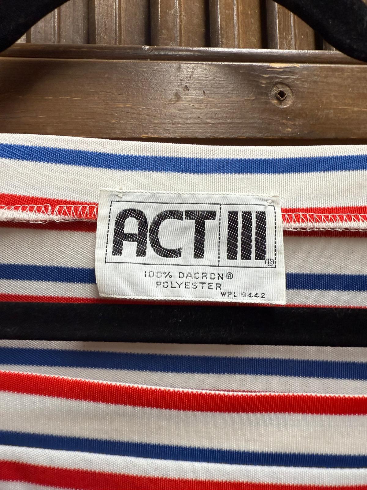 Striped fabric with a 'ACT' label on a wooden surface