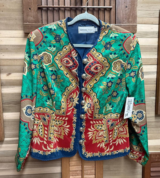 Colorful embroidered jacket hanging against a wooden background
