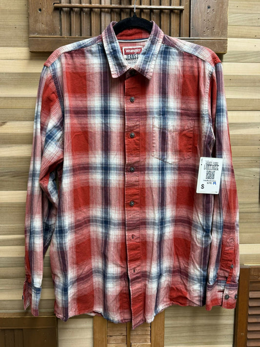 Red and white plaid shirt on a hanger against a wooden panel background