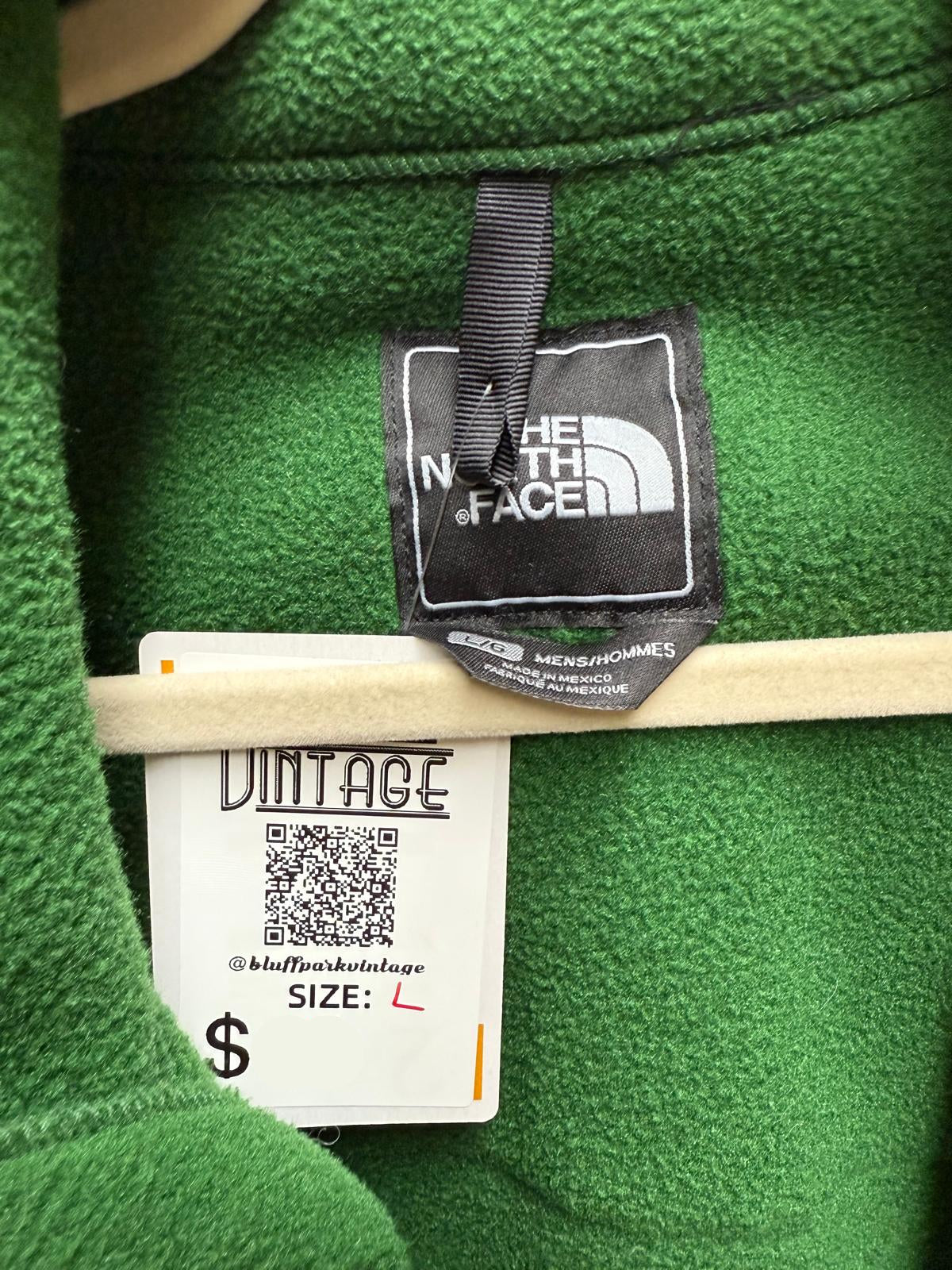 Green jacket with The North Face label and vintage tag.
